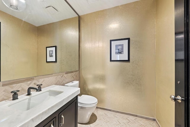 bathroom featuring decorative backsplash, toilet, and vanity