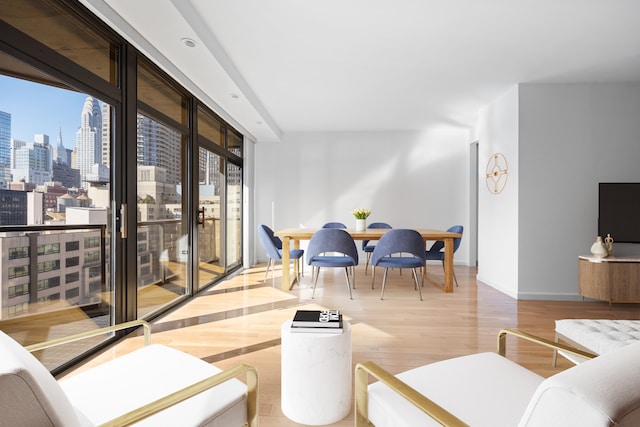 100 United Nations Plz Unit 20E, New York City, NY 10017 - living area with a skyline view, wood finished floors, and baseboards