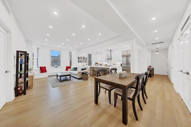 dining area featuring light wood finished floors and recessed lighting