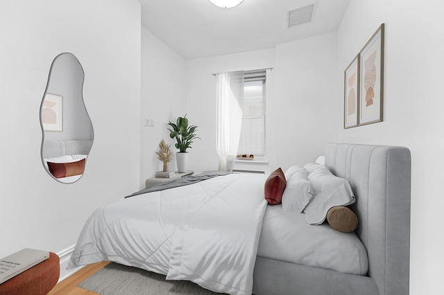 bedroom featuring wood finished floors and baseboards