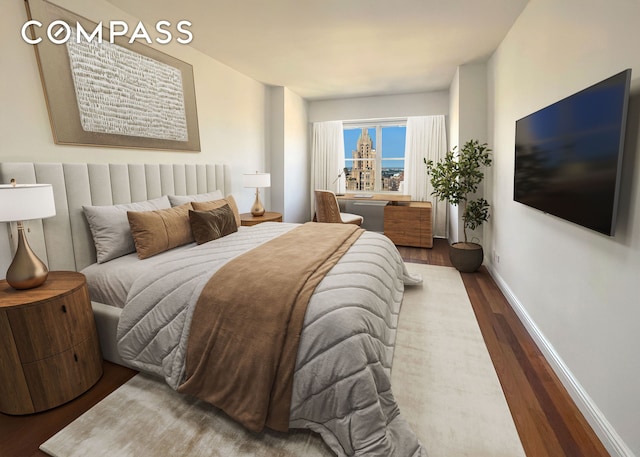 bedroom featuring wood finished floors and baseboards