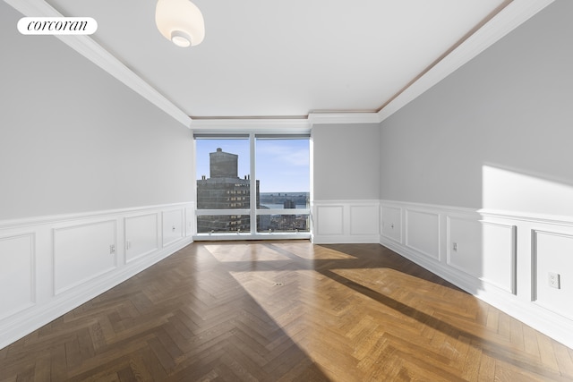 spare room with ornamental molding, a view of city, visible vents, and a decorative wall