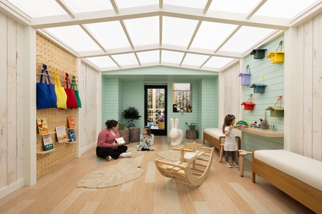 living room featuring light parquet flooring and beam ceiling