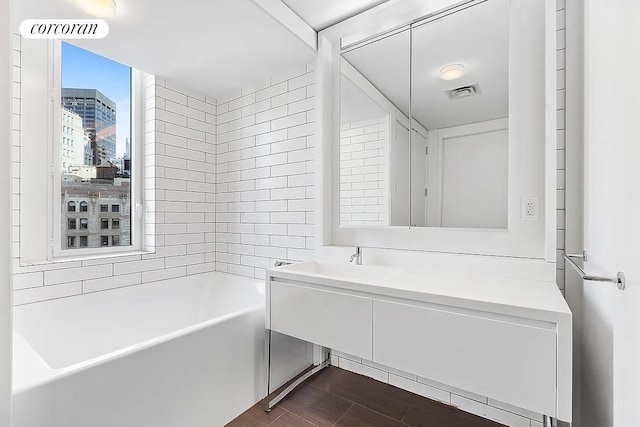 full bathroom featuring visible vents, wood finished floors, and vanity