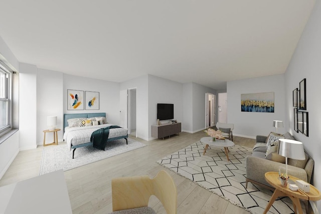 bedroom featuring light wood-style flooring and baseboards