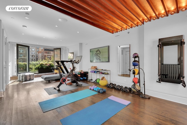 workout area featuring plenty of natural light, wood finished floors, and visible vents