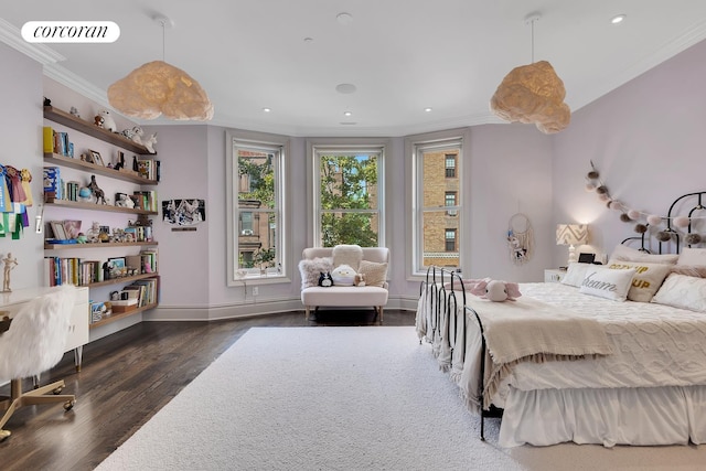 bedroom with crown molding, wood finished floors, visible vents, and baseboards