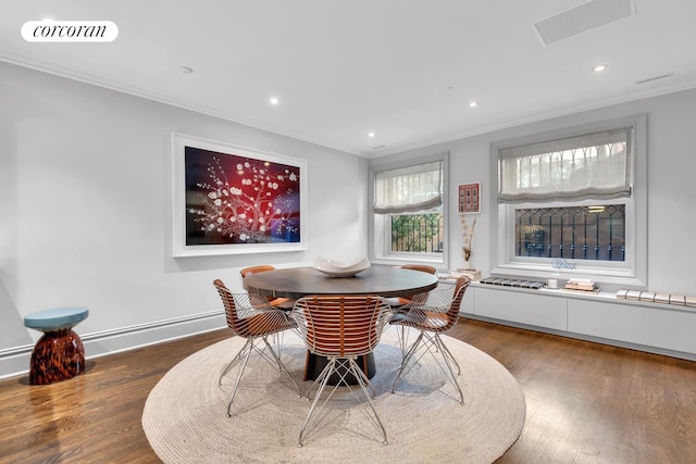 dining space featuring wood finished floors, visible vents, baseboards, recessed lighting, and crown molding