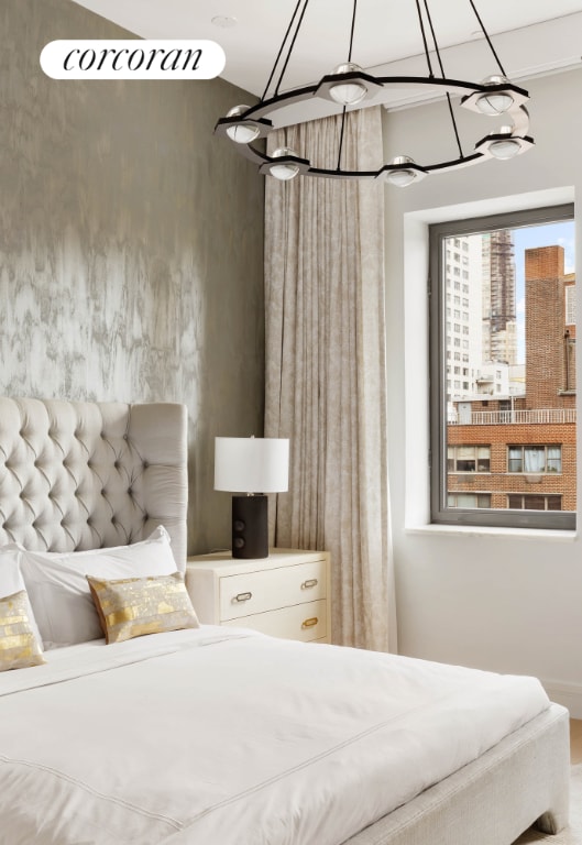 bedroom with a chandelier and hardwood / wood-style flooring