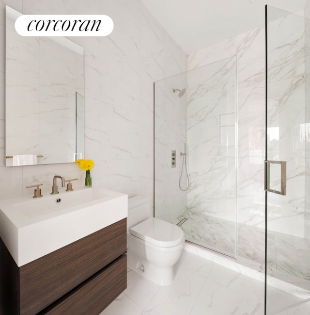 bathroom featuring tile walls, toilet, vanity, and an enclosed shower