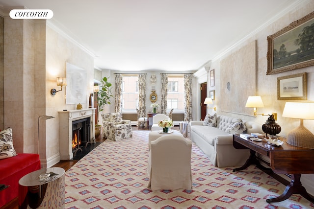 living room with crown molding, a lit fireplace, and wood finished floors