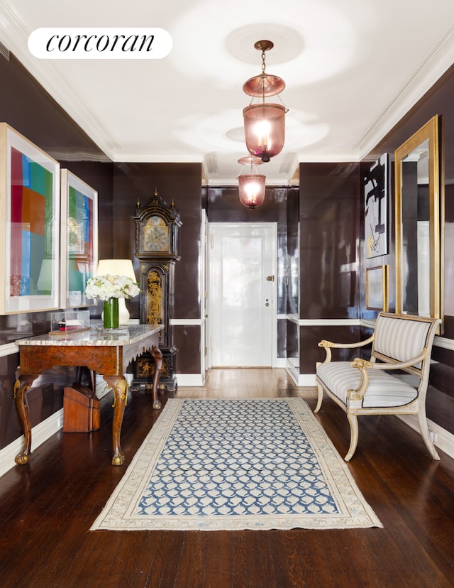 entrance foyer featuring wood-type flooring and ornamental molding