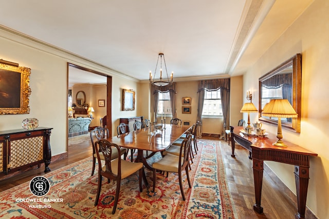 dining space with hardwood / wood-style floors and ornamental molding