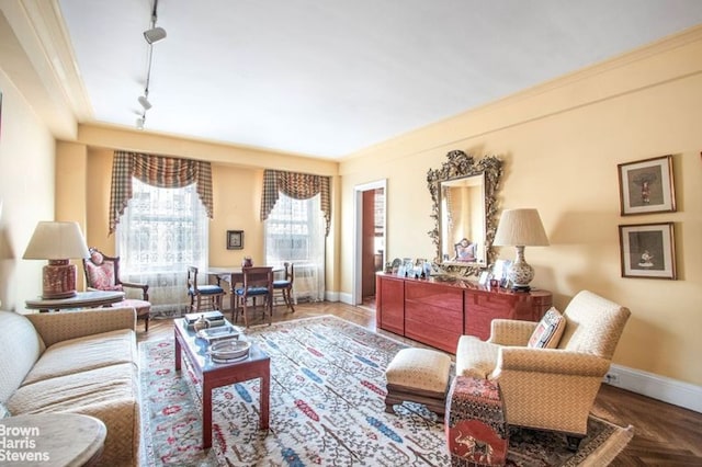 sitting room with crown molding, rail lighting, and parquet flooring