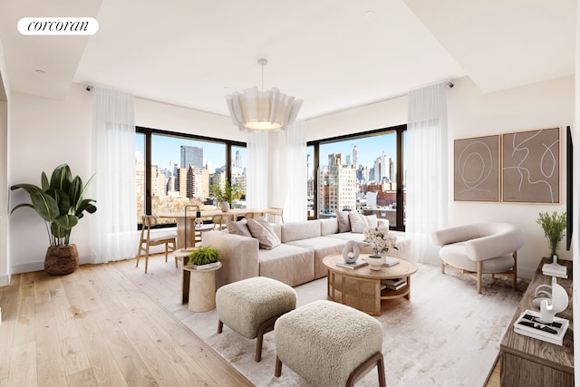 living room featuring visible vents, a city view, and light wood-style flooring