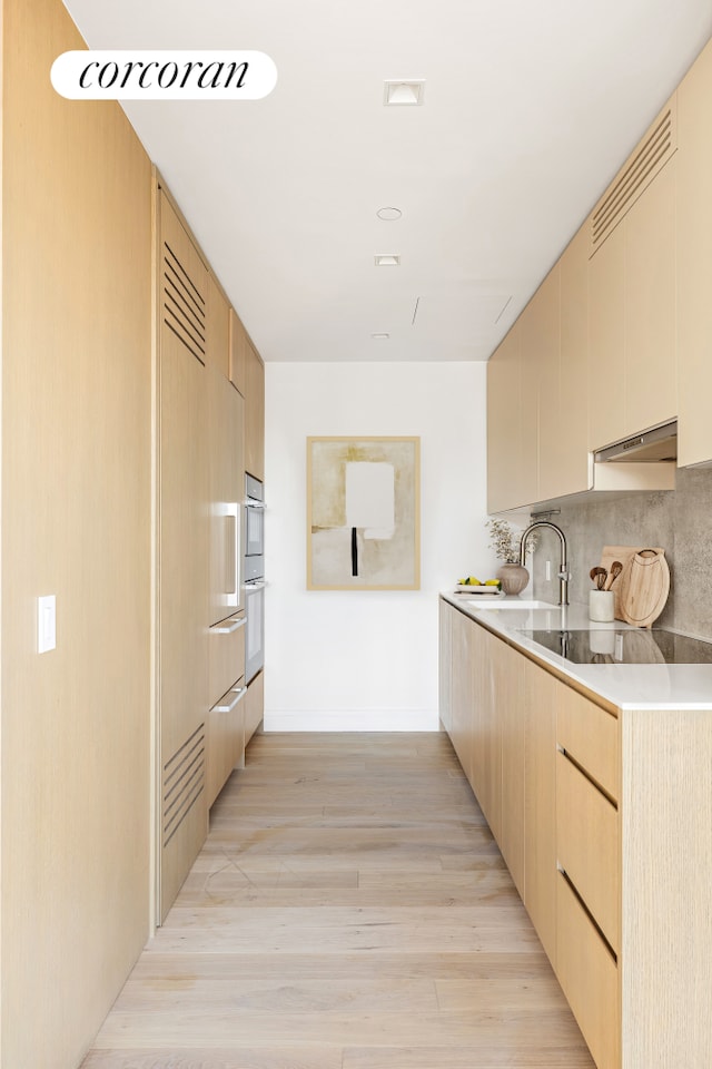 kitchen with visible vents, white double oven, black electric stovetop, under cabinet range hood, and decorative backsplash