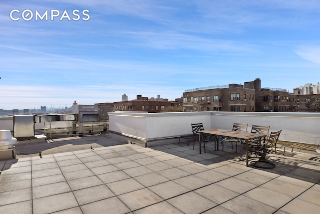 view of patio / terrace featuring outdoor dining area and a city view