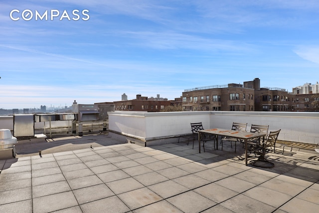view of patio with a city view and outdoor dining area