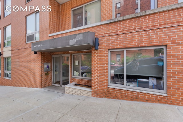 entrance to property with brick siding