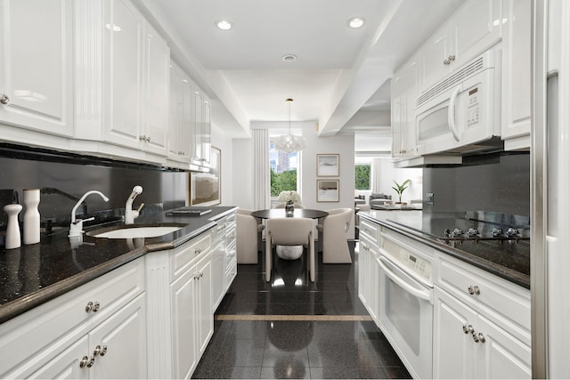 860 5th Ave Unit 7B, New York City, NY 10065 - kitchen featuring white appliances, a sink, white cabinetry, granite floors, and recessed lighting