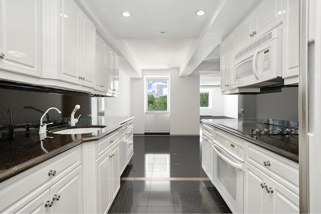 860 5th Ave Unit 7B, New York City, NY 10065 - kitchen featuring white appliances, a sink, white cabinets, recessed lighting, and baseboards