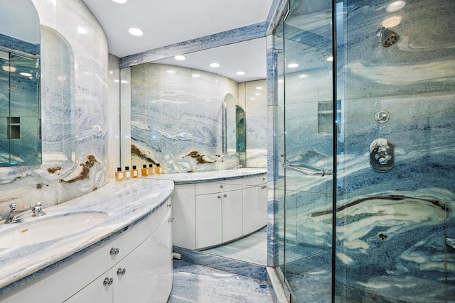 860 5th Ave Unit 7B, New York City, NY 10065 - bathroom with two vanities, a shower stall, and recessed lighting
