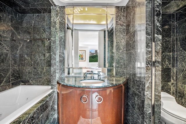 860 5th Ave Unit 7B, New York City, NY 10065 - bathroom with tile walls, toilet, and vanity