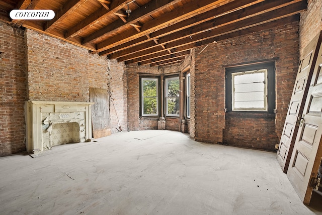 872 Park Place, New York City, NY 11216 - unfurnished living room with brick wall and wooden ceiling with exposed beams