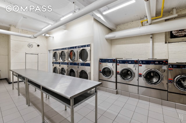 common laundry area with stacked washer and dryer, tile patterned flooring, and separate washer and dryer