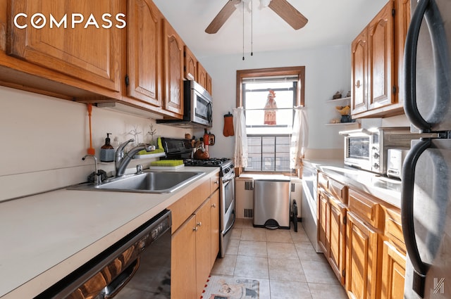 25-40 31st Ave Unit 6M, New York City, NY 11106 - kitchen with stainless steel appliances, a sink, light countertops, a ceiling fan, and brown cabinets