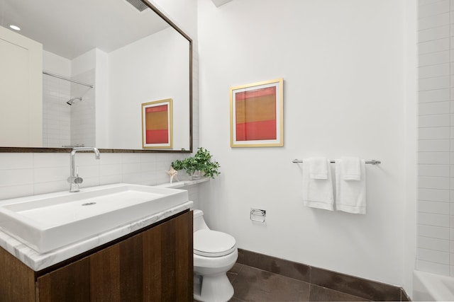 full bathroom with toilet, tile patterned flooring, vanity, and baseboards