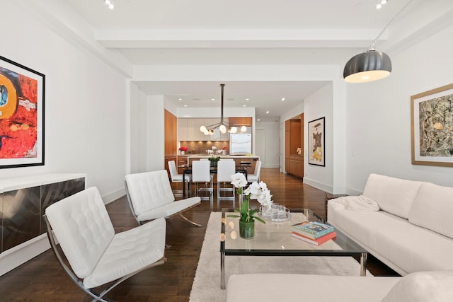 living room with dark wood-style flooring, baseboards, beamed ceiling, and a chandelier