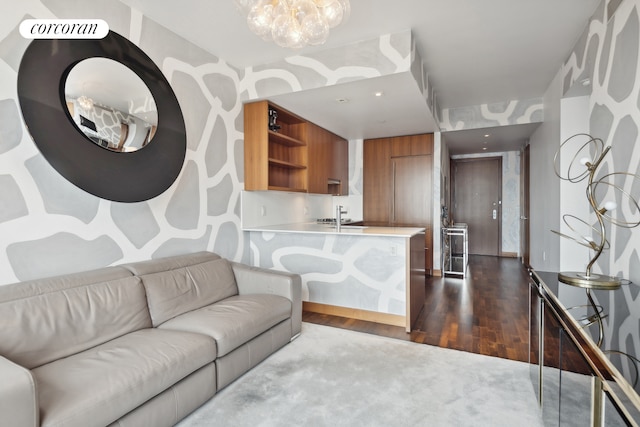 living area with an inviting chandelier and wood finished floors