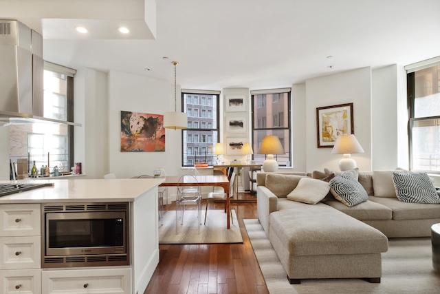 living room with recessed lighting and dark wood-style flooring