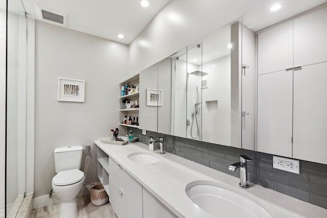 full bath with visible vents, a sink, toilet, and a walk in shower