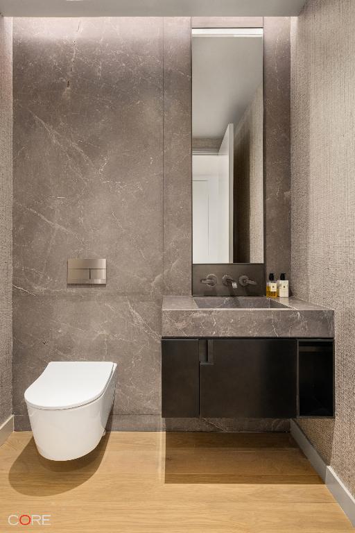 bathroom with hardwood / wood-style flooring, vanity, and toilet