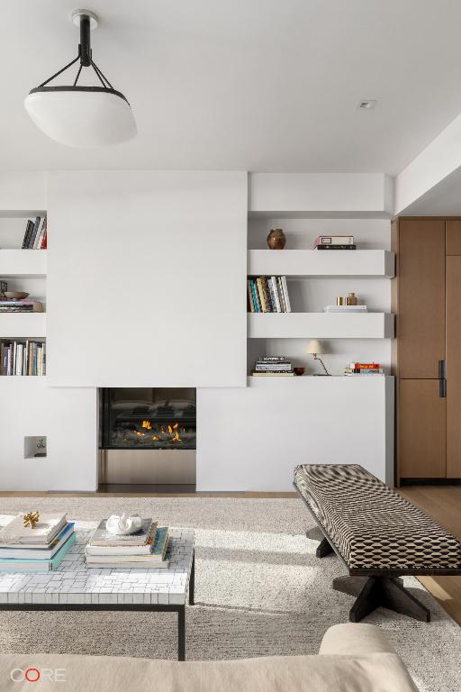 living room featuring hardwood / wood-style flooring and built in shelves