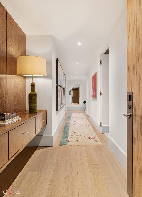 hall with light hardwood / wood-style floors