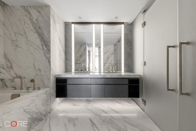 555 W 22nd St Unit 8Aw, New York City, NY 10011 - bathroom featuring double vanity, a garden tub, a marble finish shower, and marble finish flooring