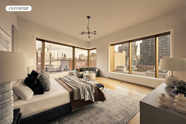 bedroom with an inviting chandelier and light hardwood / wood-style floors