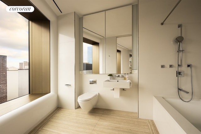 bathroom with tile patterned flooring, sink, toilet, and a shower