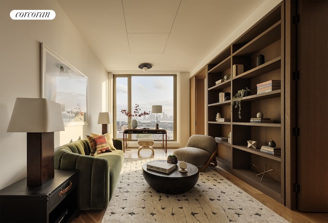 sitting room featuring expansive windows and hardwood / wood-style floors