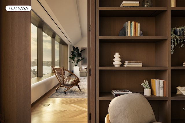 home office with parquet floors, built in shelves, and built in desk