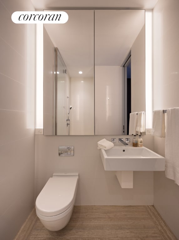 bathroom with toilet and hardwood / wood-style floors