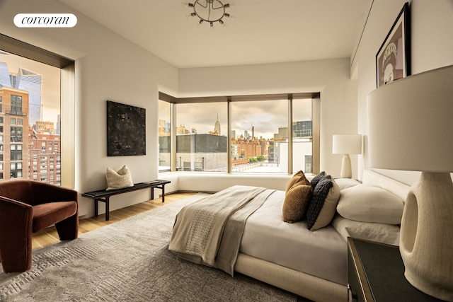 bedroom with a city view, wood finished floors, and visible vents