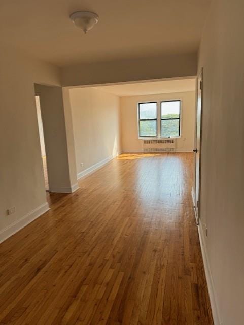 empty room with hardwood / wood-style floors and a wall unit AC