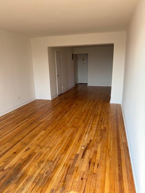 unfurnished room with hardwood / wood-style floors