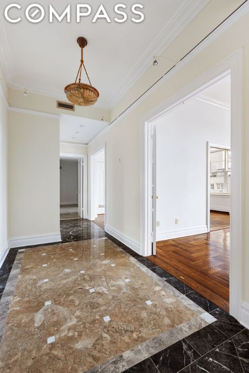 unfurnished room with ornamental molding