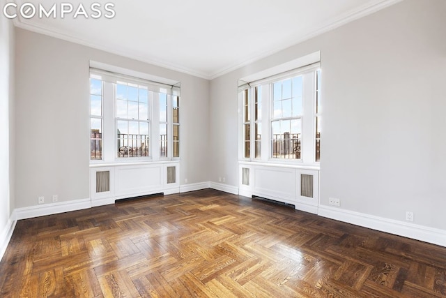 empty room with ornamental molding, parquet floors, and a healthy amount of sunlight