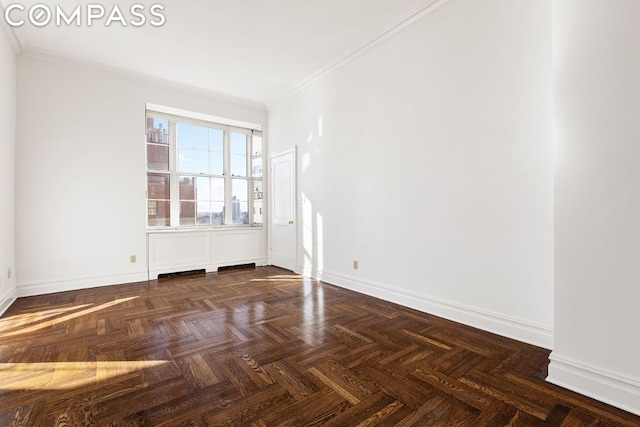 empty room featuring ornamental molding and dark parquet floors